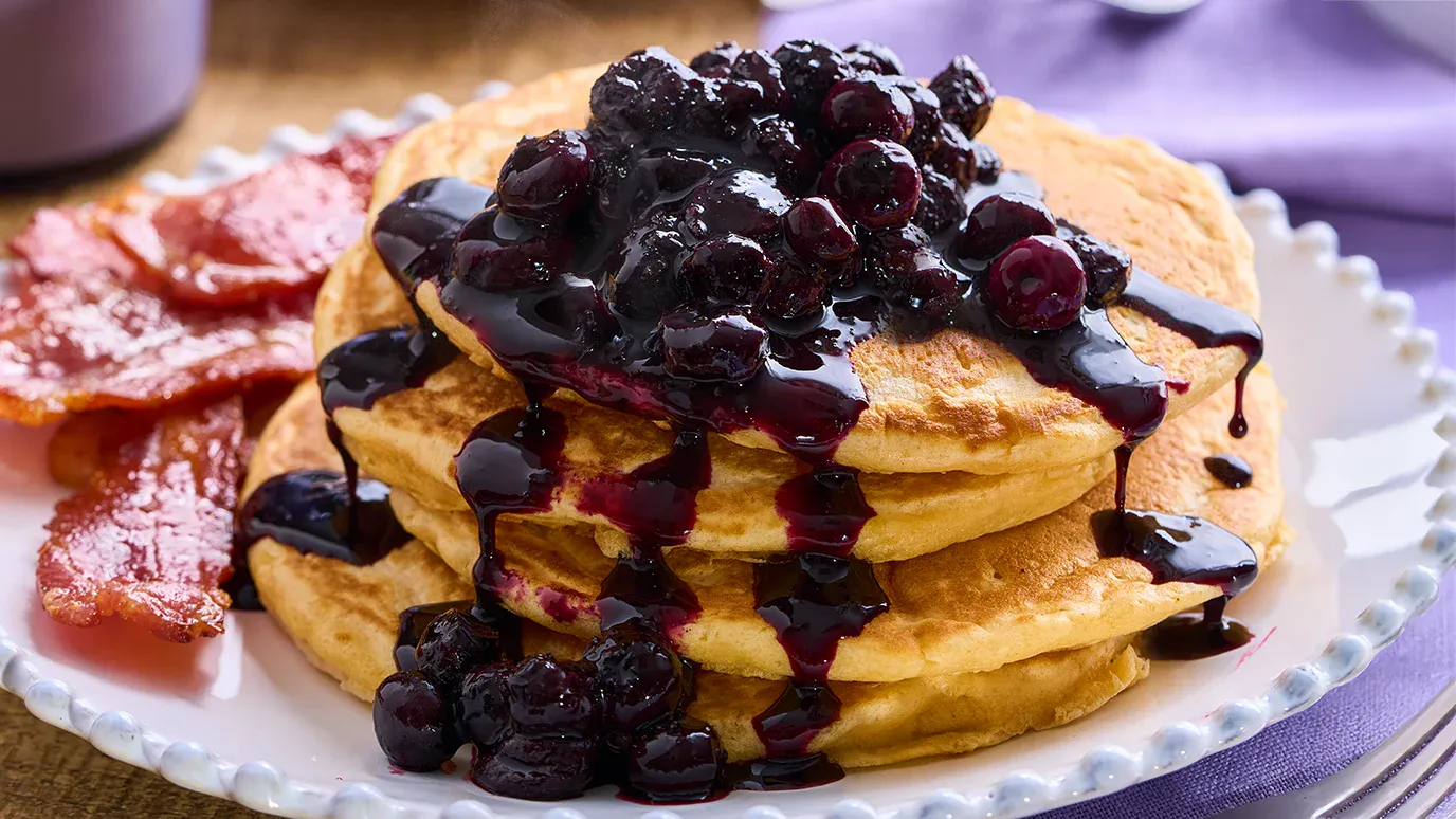 Fluffy pancakes with blueberry compote and crispy bacon