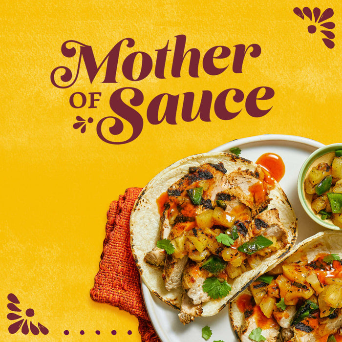 A vibrant graphic featuring the words Mother of Sauce above a plate of grilled chicken tacos drizzled with Cholula Original Mexican Hot Sauce 150Ml and topped with pineapple salsa.