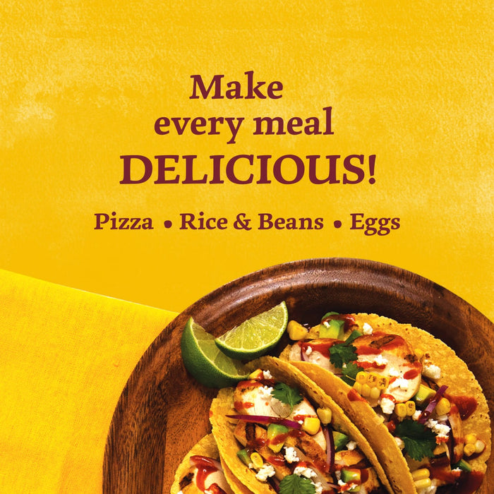 A vibrant advertisement for Cholula Original Mexican Hot Sauce 150Ml featuring chicken tacos topped with corn and cilantro alongside text suggesting it makes every meal delicious.