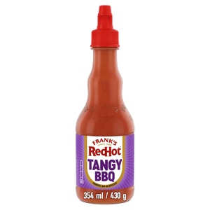 A bottle of Frank'S Redhot Franks Squeeze Tangy Bbq 354 Ml featuring a purple label and a red squeeze cap against a black background.