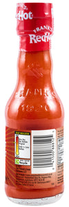 The back of a glass bottle of Franks Rdhot Orig Gb 24/148 Ml shows the label with a heat indicator, barcode, and nutritional information.