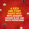 Black and white peppercorns float around text describing the rich and fiery flavor of Schwartz Creamy Pepper Sauce Mix 25G against a textured red background.