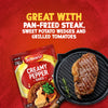 A packet of Schwartz Creamy Pepper Sauce Mix 25G is displayed next to a perfectly pan-fried steak in a cast-iron grill pan, illustrating a delicious serving suggestion.