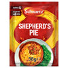 A red packet of Schwartz Shepherd'S Pie Recipe Mix 38G is displayed in front of a serving suggestion of a finished shepherd's pie in a terracotta dish, accompanied by green peas and broccoli.