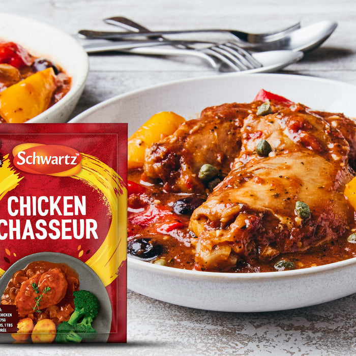 A packet of Schwartz Chicken Chasseur Recipe Mix 40G is displayed next to a plated serving of the finished dish featuring tender chicken pieces in a rich tomato and mushroom sauce with olives and capers.
