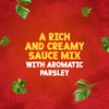 A promotional image for Schwartz Creamy Parsley Sauce 26G shows the text A rich and creamy sauce mix with aromatic parsley on a red textured background with fresh parsley leaves.
