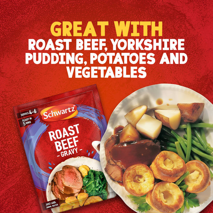 A packet of Schwartz Roast Beef Gravy Mix 27G is displayed next to a plate of roast beef, Yorkshire pudding, potatoes, and vegetables, illustrating a perfect meal pairing.