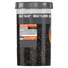 A large clear container of Schwartz Medium Black Peppercorns 100G showing the whole dried berries through the plastic and providing culinary tips on the back label.