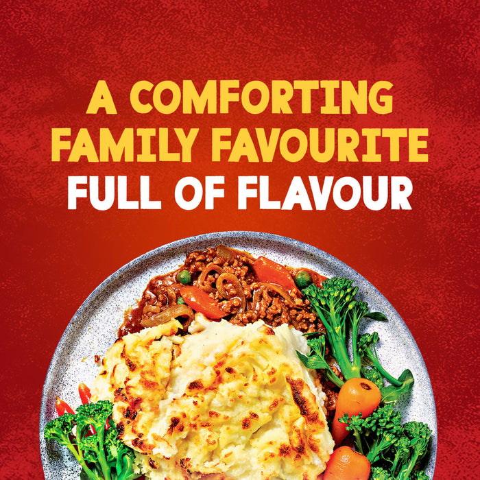 A comforting plate of Sa Cottage Pie, featuring a savory mince base topped with golden-brown mashed potatoes and served with broccoli and carrots, is shown against a red background with text that reads, A comforting family favourite full of flavour.