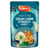 A microwaveable pouch of Schwartz Fish Lemon & Parsley Sauce 300G featuring a serving suggestion of white fish with roasted potatoes and greens.