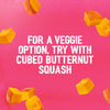 Cubed butternut squash floats on a pink background, illustrating a veggie serving suggestion for the Schwartz Las Iguanas Bahian Coconut Curry 25G.