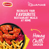 A promotional graphic for Schwartz Las Iguanas Honey Chilli Chicken 35G shows a plate of glazed chicken wings and fries against a vibrant pink background to inspire recreating restaurant meals at home.