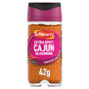 A clear glass jar of Schwartz Extra Spicy Cajun 42G Grill&Sizzl seasoning featuring a vibrant pink label with illustrations of red chili peppers and herbs.