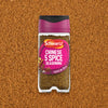 A jar of Schwartz Chinese 5 Spice Seasoning 58G is centered against a background of the finely ground brown spice blend.