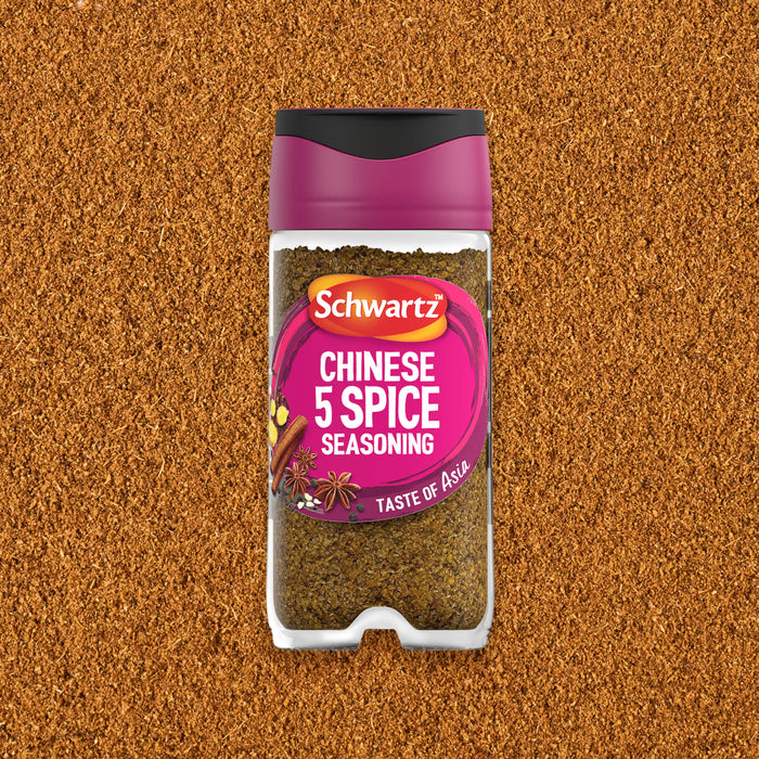 A jar of Schwartz Chinese 5 Spice Seasoning 58G is centered against a background of the finely ground brown spice blend.