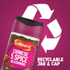 A promotional graphic featuring a bottle of Schwartz Chinese 5 Spice Seasoning 58G set against a large white recycling symbol to highlight its recyclable jar and cap.