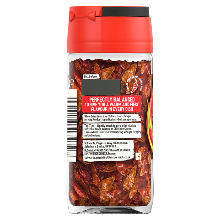 The back label of a jar of Schwartz Birds Eye Chillies 11G provides usage tips and heat level information for the whole dried peppers visible inside.