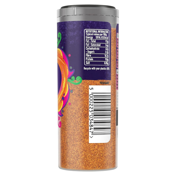 A side view of a clear plastic jar containing Schwartz Tikka Curry Spice 85G showing the nutritional information and barcode on a purple and orange label.
