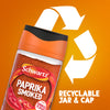 A jar of Schwartz Smoked Paprika 40G is set against an orange background with a large recycling symbol to highlight that the jar and cap are recyclable.