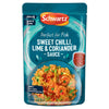 A 300g microwaveable pouch of Schwartz Chilli Lime Coriander Wet Sauce For Fish 300G featuring a serving suggestion of shrimp and rice in a blue bowl.