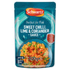 A 300g pouch of Schwartz Chilli Lime Coriander Wet Sauce For Fish 300G featuring a vibrant teal background and a serving suggestion of shrimp and rice.