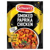 A 28g packet of Schwartz Smoked Paprika Chicken 28G seasoning mix featuring a vibrant yellow brushstroke design and a bowl of prepared chicken with peppers and chorizo.
