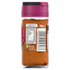 The back label of a glass jar of Schwartz Smoky Cajun Seasoning 45G displays nutritional information and recycling instructions against the backdrop of the orange spice blend.