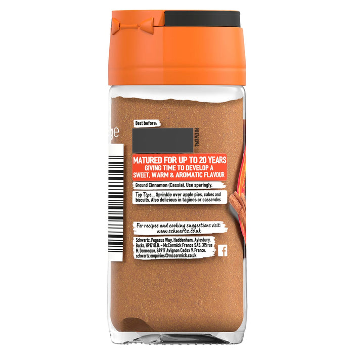 The back of a glass jar of Schwartz Ground Cinnamon 39G is shown against a white background, with the label detailing cooking suggestions, ingredients, and company information.