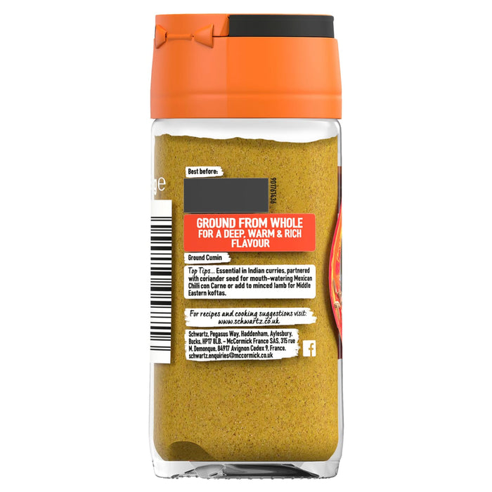 A clear glass jar of Schwartz Ground Cumin 37G is shown from the back, displaying the label with usage tips, company information, and the brand's website.