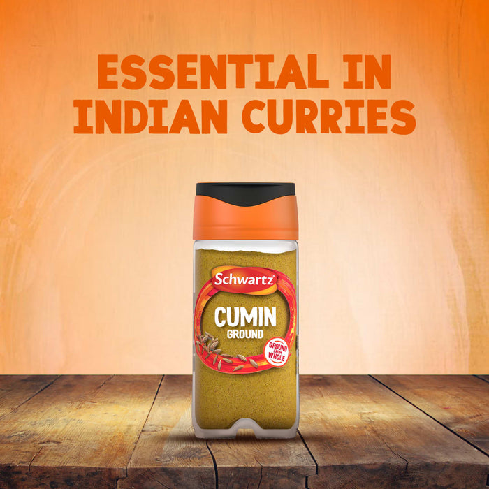 A jar of Schwartz Cumin Ground 37G is shown on a wooden table, with text in the background reading Essential in Indian Curries.