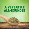 A wooden spoon overflowing with Schwartz Mixed Herbs 11G rests on a rustic wooden table against a green background with the text A VERSATILE ALL-ROUNDER.