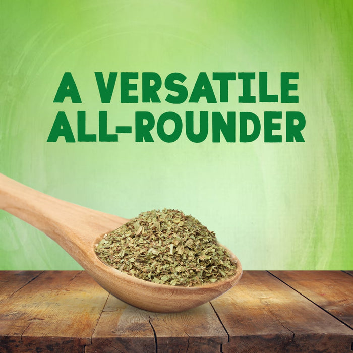A wooden spoon overflowing with Schwartz Mixed Herbs 11G rests on a rustic wooden table against a green background with the text A VERSATILE ALL-ROUNDER.