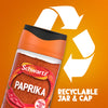 A jar of Schwartz Paprika 40G is shown against an orange background with a large recycling symbol to highlight its recyclable jar and cap.