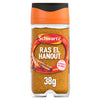 A clear glass jar of Schwartz Ras El Hanout 38G featuring an orange lid and a label with illustrations of cinnamon sticks and ginger root.