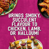 A vibrant food advertisement featuring grilled chicken wings, lamb chops with pomegranate seeds, and halloumi vegetable skewers to showcase how Schwartz Af Turki Keb Seas brings smoky succulent flavour to various dishes.