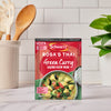 A packet of the Sa Rt Green Curry X12, which is the Schwartz Rosa's Thai Green Curry mix, is displayed on a kitchen counter to show a quick and easy meal solution.