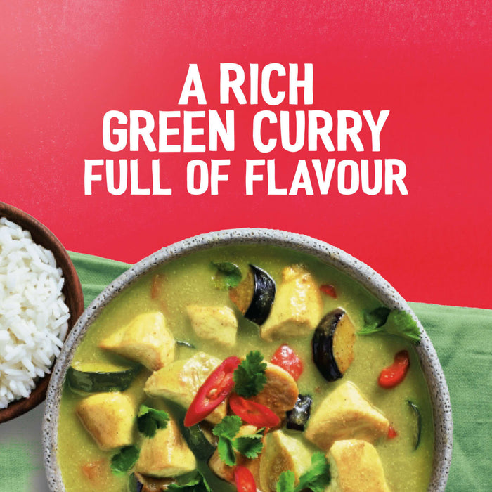 A rich bowl of Thai green curry, a dish that can be made with Sa Rt Green Curry X12, is served with a side of white rice against a red background.