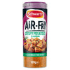 A cylindrical container of Schwartz Air-Fry Crispy Potatoes Seasoning displaying a bowl of seasoned potatoes on the label above the visible orange spice blend.