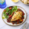 A creamy pasta bake with spinach and ricotta is seasoned with Sa Pe Smoky Bbq Chickbake X12 and served alongside a small dish of cracked black pepper.