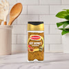 A bottle of Schwartz Jr Hot Honey Seas X6 stands on a marble countertop in a bright kitchen setting.