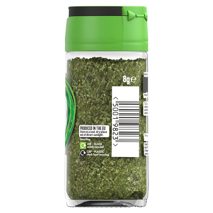 A clear glass jar of Schwartz Marjoram 8G filled with dried green herbs and featuring a white label with a barcode and recycling information.