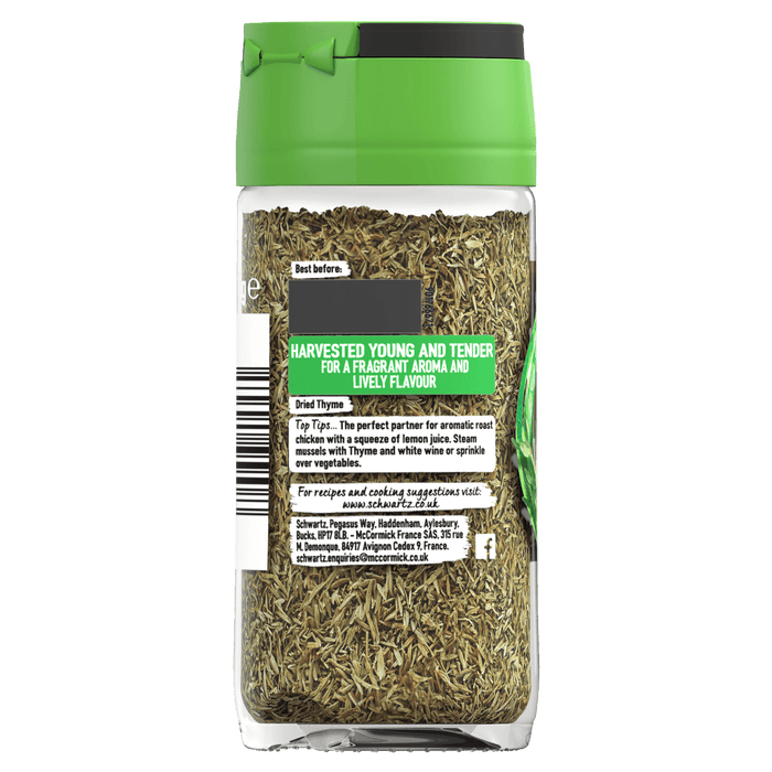 A glass jar filled with Schwartz Dried Thyme featuring a green lid and a back label detailing cooking tips and harvest information.