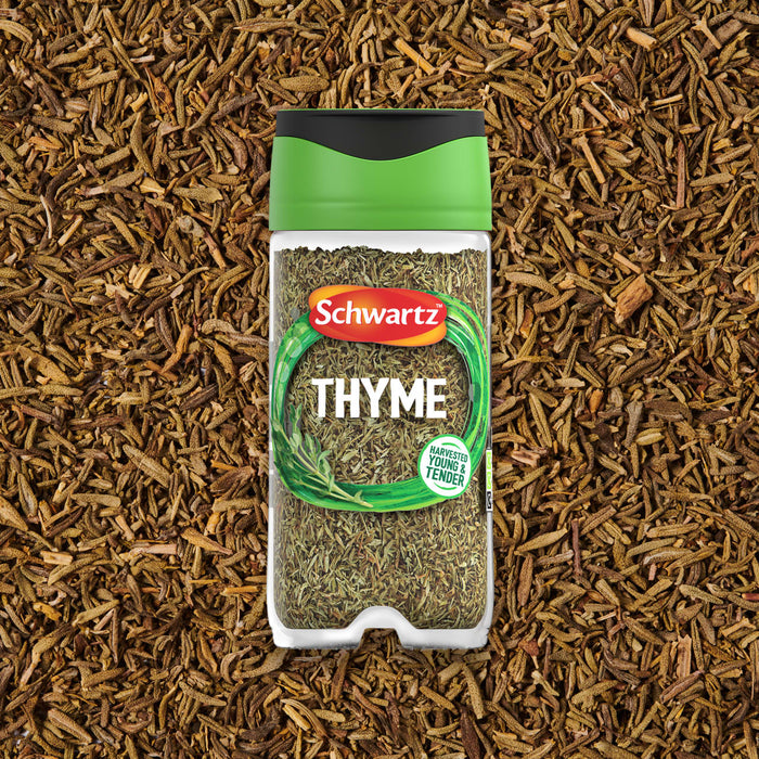 A jar of Schwartz Thyme 11 G is positioned in the center of a bed of loose, dried thyme.