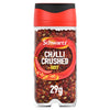 A clear plastic jar of Schwartz Crushed Chillies 29G is shown against a white background, displaying the red crushed chilli flakes inside.