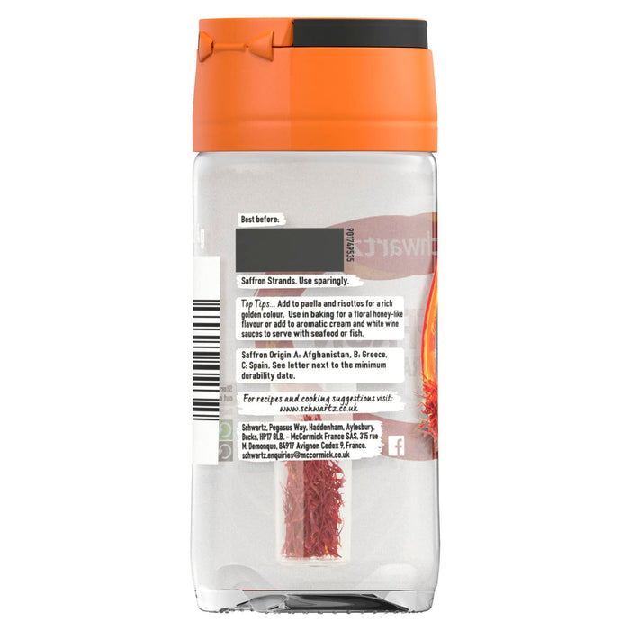 A clear glass jar of Schwartz Saffron Strands 0.4G showing the back label with cooking tips and origin information for the delicate red spice threads visible inside.