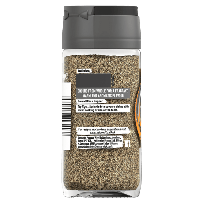 A glass jar of Schwartz Ground Black Pepper showing the back label with usage tips and company details.