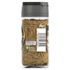 A clear glass jar of Schwartz Black Pepper Mild Coarse Ground 33G shows the textured spice blend through the side of the bottle with recycling information and a barcode on the label.