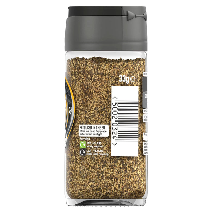 A clear glass jar of Schwartz Black Pepper Mild Coarse Ground 33G shows the textured spice blend through the side of the bottle with recycling information and a barcode on the label.