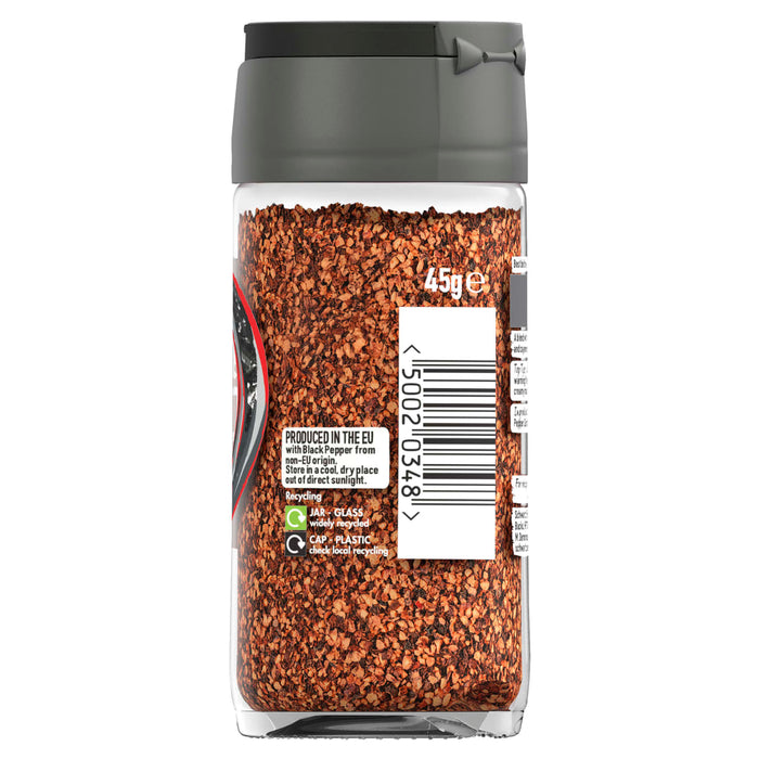A back view of a glass jar of Schwartz Black And Red Pepper, 45G showing the barcode and recycling information for the glass jar and plastic cap.