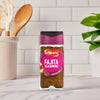 A bottle of Schwartz Fajita Seasoning 46G stands on a marble countertop in a bright kitchen setting.